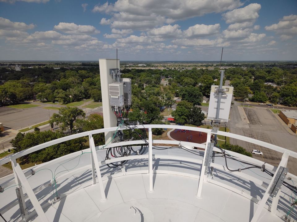 Close aerial view of cellular antenna equipment mounted on a water tower