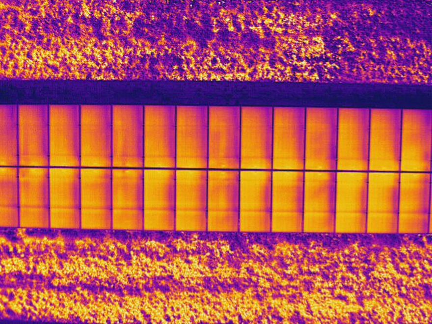 Aerial thermal image of a solar panel row under load